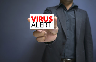 men in suit holding white Label VIRUS ALERT