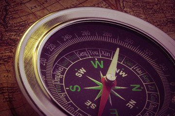 Old compass on vintage map