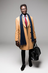 african american businessman travel with bag in coat isolated