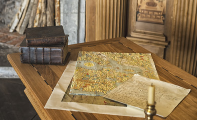 Vintage books with map at the wooden table