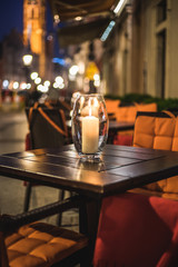 Cafe table with candle on the nightly street