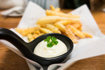 French fries with sauce on wooden table in restaurant .Selective focus