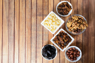 Different dried fruits over wooden background