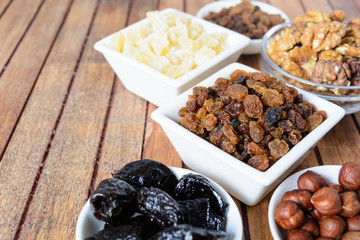 Different dried fruits over wooden background