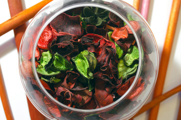 Aroma incense and flower petals in the jar. Beauty spa salon top view background.