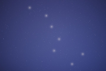 The constellation of a big bear in the night blue sky.