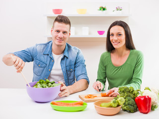 Young couple cooking in their kitchen. 