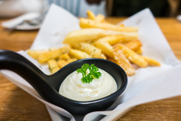 French fries with sauce on wooden table in restaurant .Selective focus