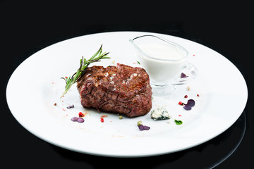 Grilled pork meat on a white plate