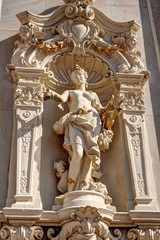Fototapeta na wymiar Art statuette of the half naked lady holding harp