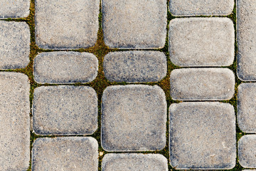 Part of road paved with the cobble stones. Stone background
