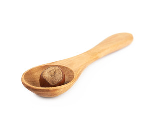 Hazelnut in a wooden spoon isolated