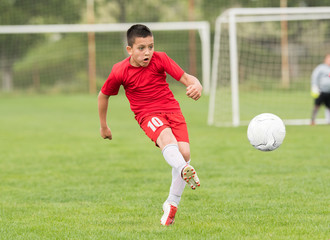 Kids soccer football - children players match on soccer field