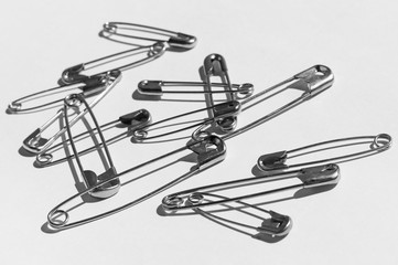 Fototapeta premium black and white clasp pins on white background