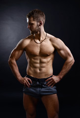Obraz na płótnie Canvas Young bodybuilder on a black background