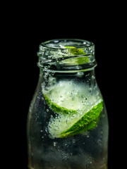 Close up of lemon soda on the black background.