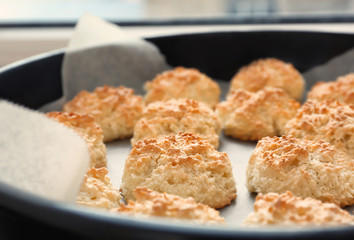 Baking tray with delicious coconut macaroons, closeup