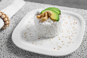 Plate with delicious tasty coconut rice on table