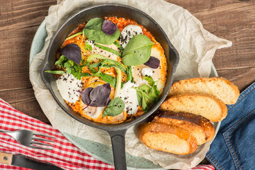 Breakfast with eggs, cheese, basil and onions