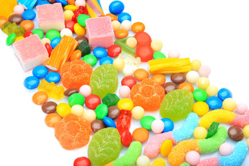 Fototapeta na wymiar Tasty and colorful candies on white background