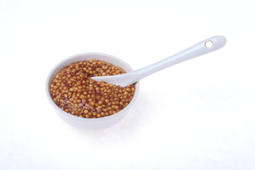 Typical french dijon rough mustard in bowl from isolated on white background