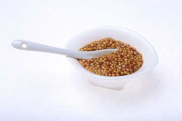Typical french dijon rough mustard in bowl from isolated on white background