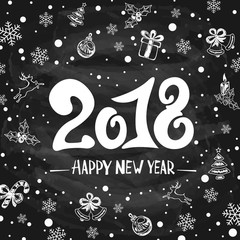 2018 New Years greetings with holiday decorations on black chalkboard background