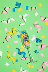 Celebration Flat lay with colorful party items on green background.