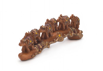 Seven Indian elephants made of sandalwood on a white background
