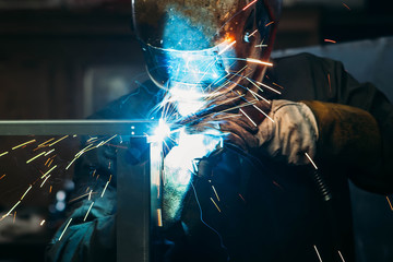sparks while welder uses torch to welding - obrazy, fototapety, plakaty