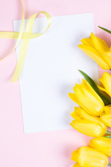 Bouquet of beautiful fresh yellow tulips on pink background