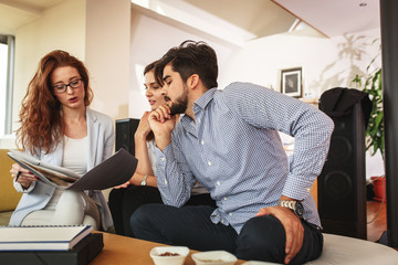 Female Real Estate agent offer home ownership and life insurance to young couple.