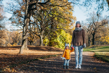 mother and daughter standing in the park