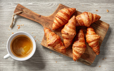 freshly baked croissants and coffee cup