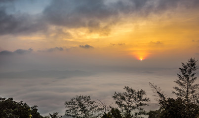Fototapeta premium Aerial view of sunrise over mountain and fog in Nan province, Thailand. Doi Samoe Dao at Sri Nan National Forest Park, Northern of Thailand.