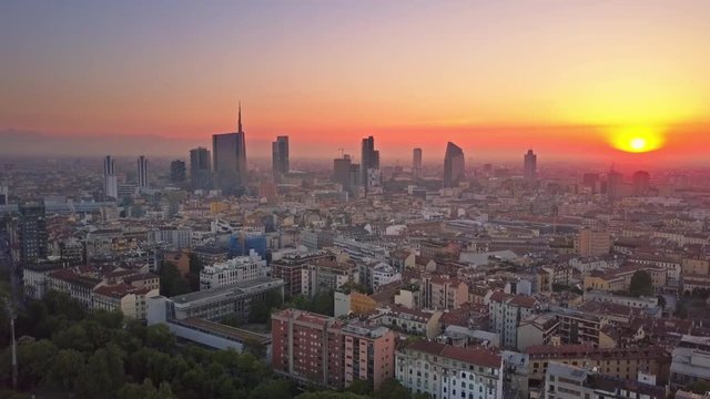 milan city skyline aerial view at sunrise flying backwards