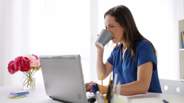 woman with laptop and coffee at home or office