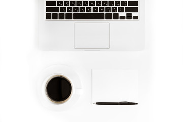 Top view of laptop and cup of coffee at workplace isolated on white, wireless communication concept