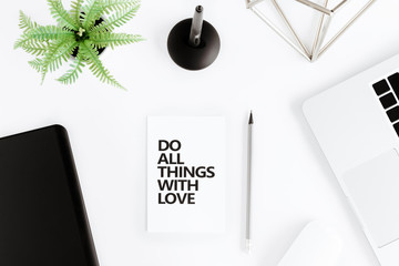flat lay with Do all things with love motivational quote on modern workplace with wireless devices