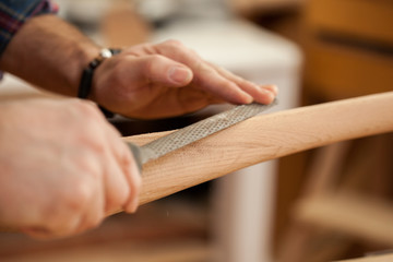 Carpenter Making Cabrioli Table (or Chair) Legs/Middle aged handsome carpenter  making final touches to the Cabrioli table (or chair leg)