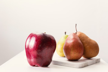 single red apple and Pear on white table