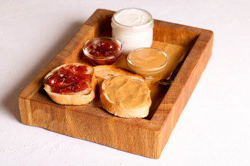 Bread toast with jelly jam and peanut butter. Sandwich for breakfast
