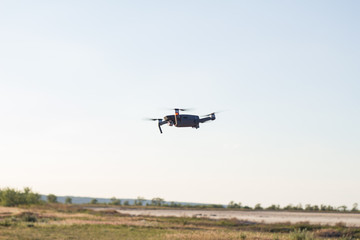 Fototapeta na wymiar Black drone flying in blue sky 