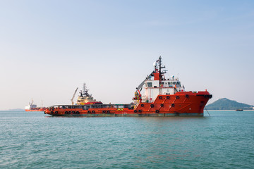 Supply ship waiting to dock in the middle of the sea.