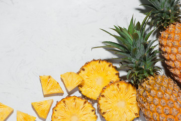 Top view of fresh sliced pineapple on a marble background.