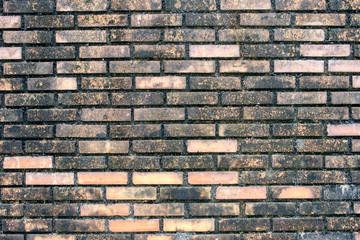 Dirty brick black orange wall
