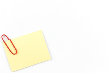 Yellow notepad with bracket on the corner and on the White table.Yellow note papers on White background.