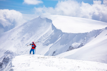 Fototapeta na wymiar skier standing on top, snow, sunny day, in Carpathian mountains, Ukraine