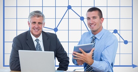 Businessmen smiling while using technologies 