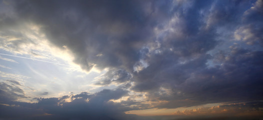 Panorama of the sunset with storm clouds